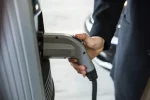 Electric vehicle EV charging station connector in hand during car charging at home or office in Kalaburagi Gulbarga Karnataka